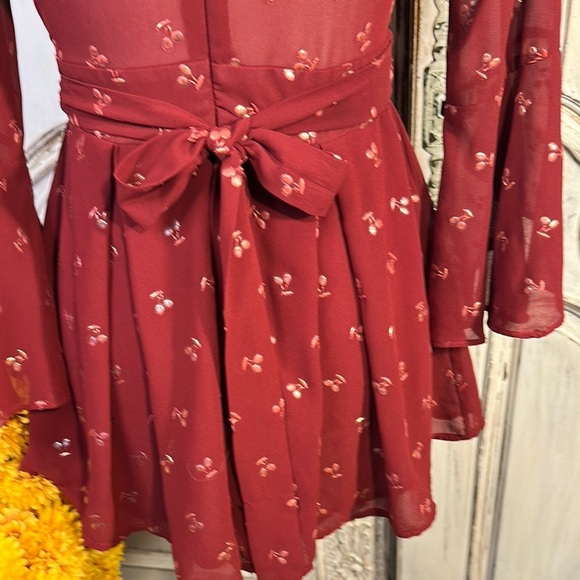 Ruby Red Ruffled Sheer Romper with Plunge Neckline and Statement Sleeves - Picture 9 of 11